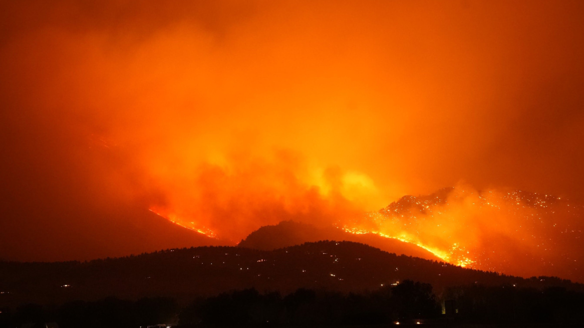 Flames light up the night sky for miles around as the CalWood fire rages through the mountains in Colorado, USA