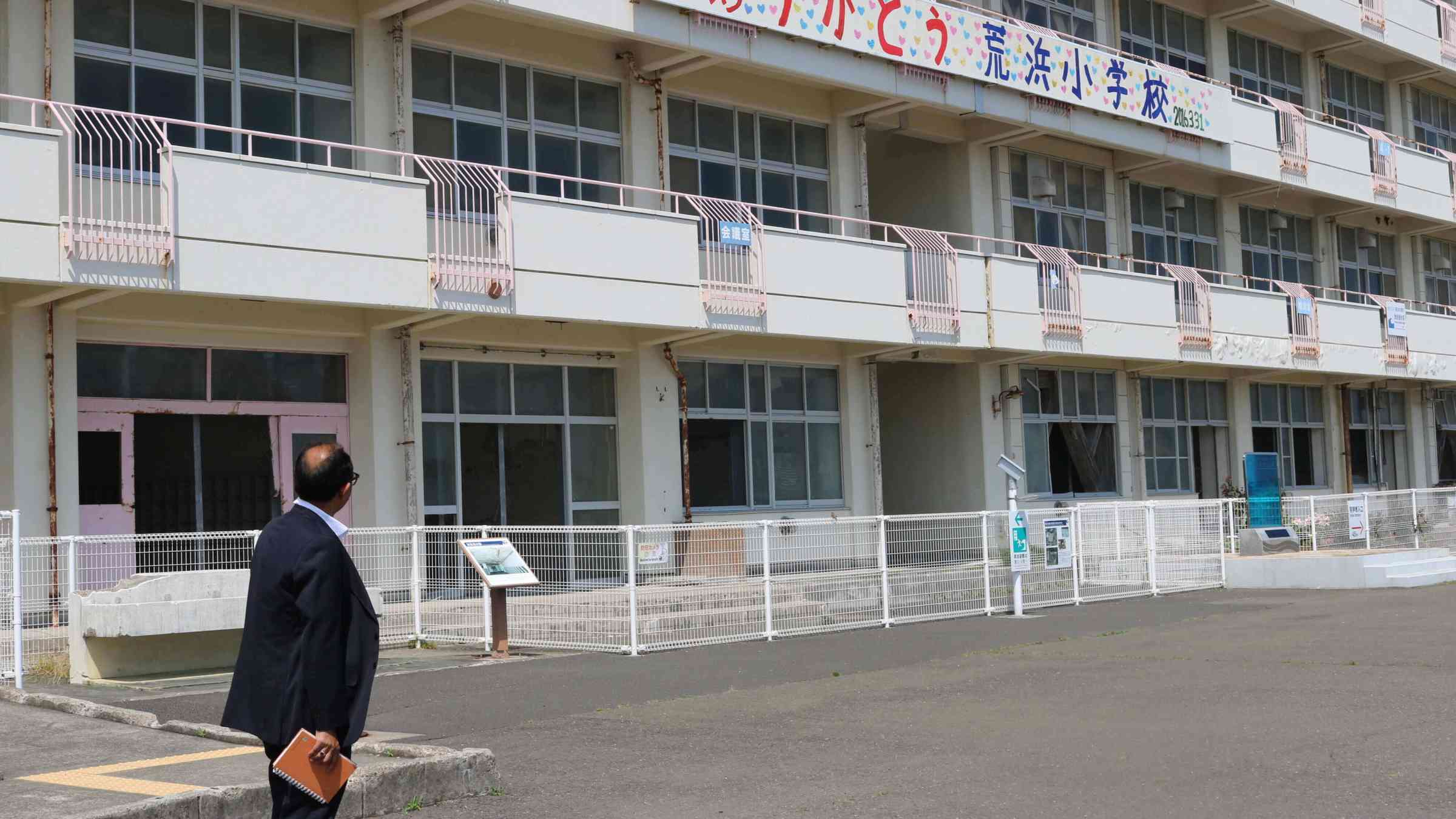 Kamal Kishore looking at a school building