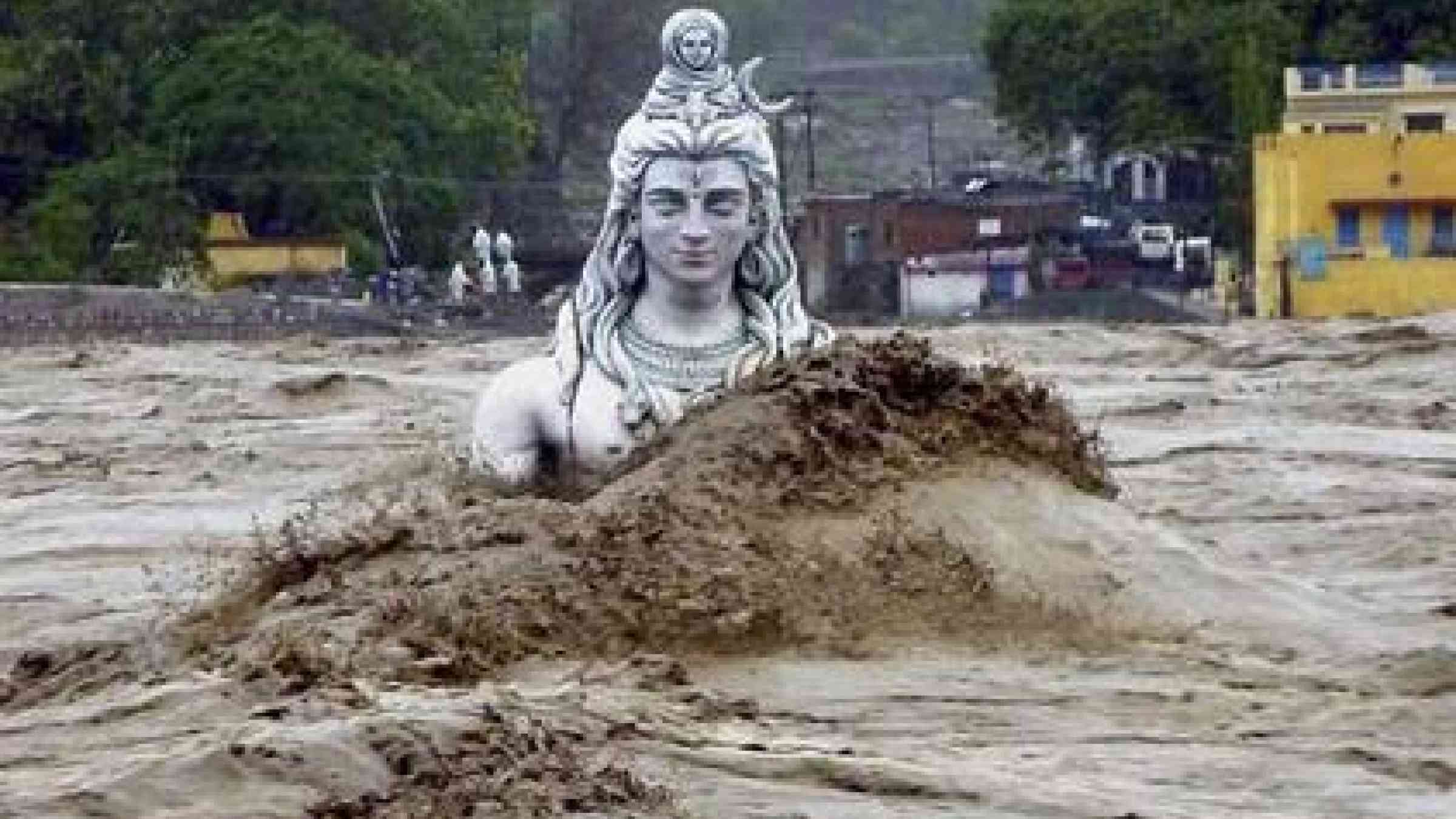 The statue of a Hindu deity is submerged by flood waters of the river Ganges in Uttarakhand, India.
