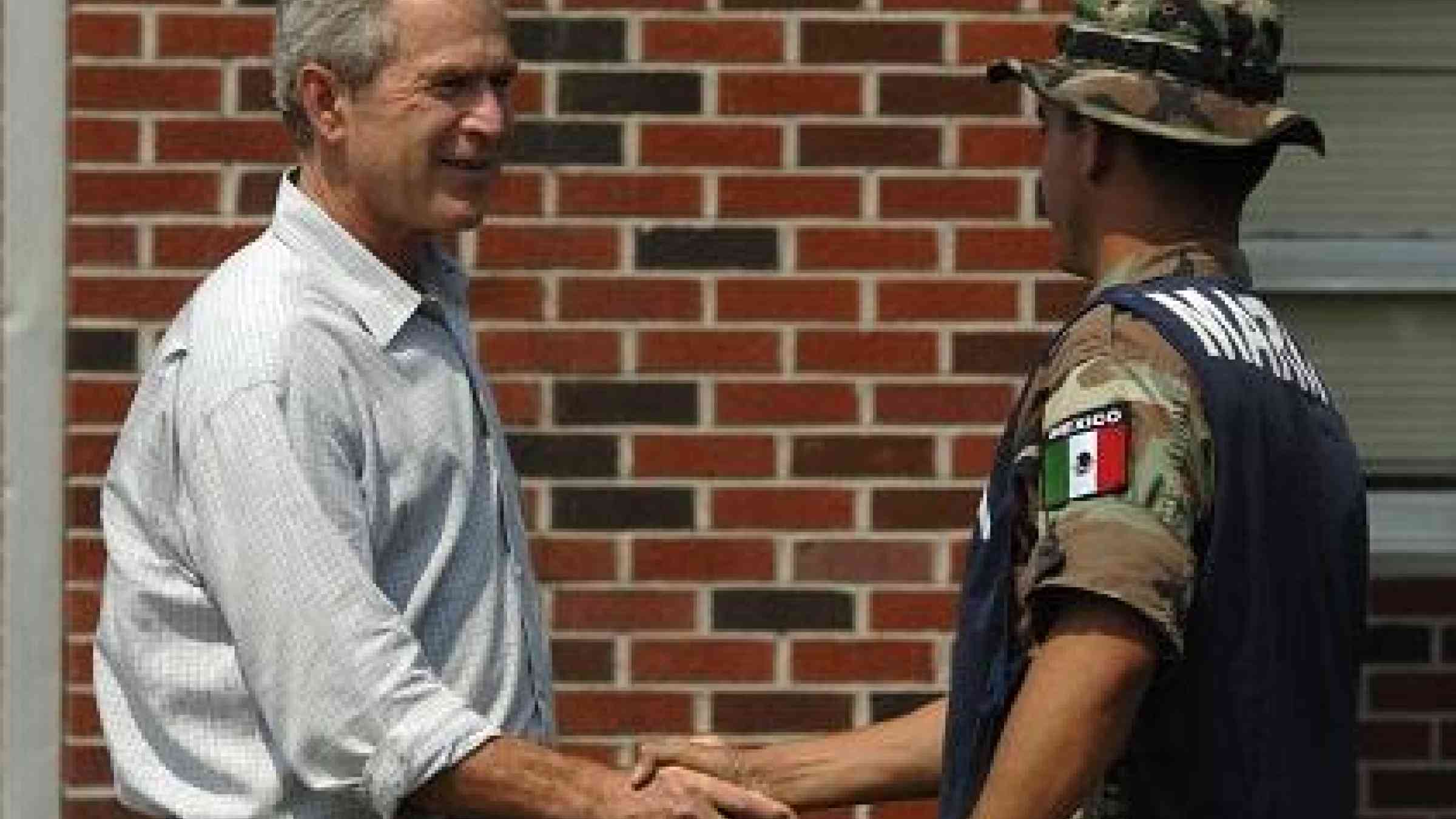 President George Bush thanks a Mexican army officer taking part in the Hurricane Katrina relief effort in 2005